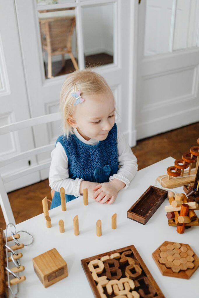 Young girl plays with educational wooden toys at home, fostering creativity and learning.